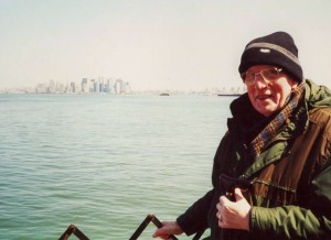 John and David visit New York in 2002. Here we're on the Stanton island ferry with the less famous skyline in the hazy background, it is only 6 months since the world trade centre was attacked, there is a powerful light beam going up into the air from ground zero every night during this first year after the attack