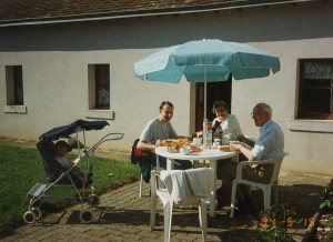 Enjoying the evening sun at our gite in Pontlevey, 1994. James sleeps away in his pram!
